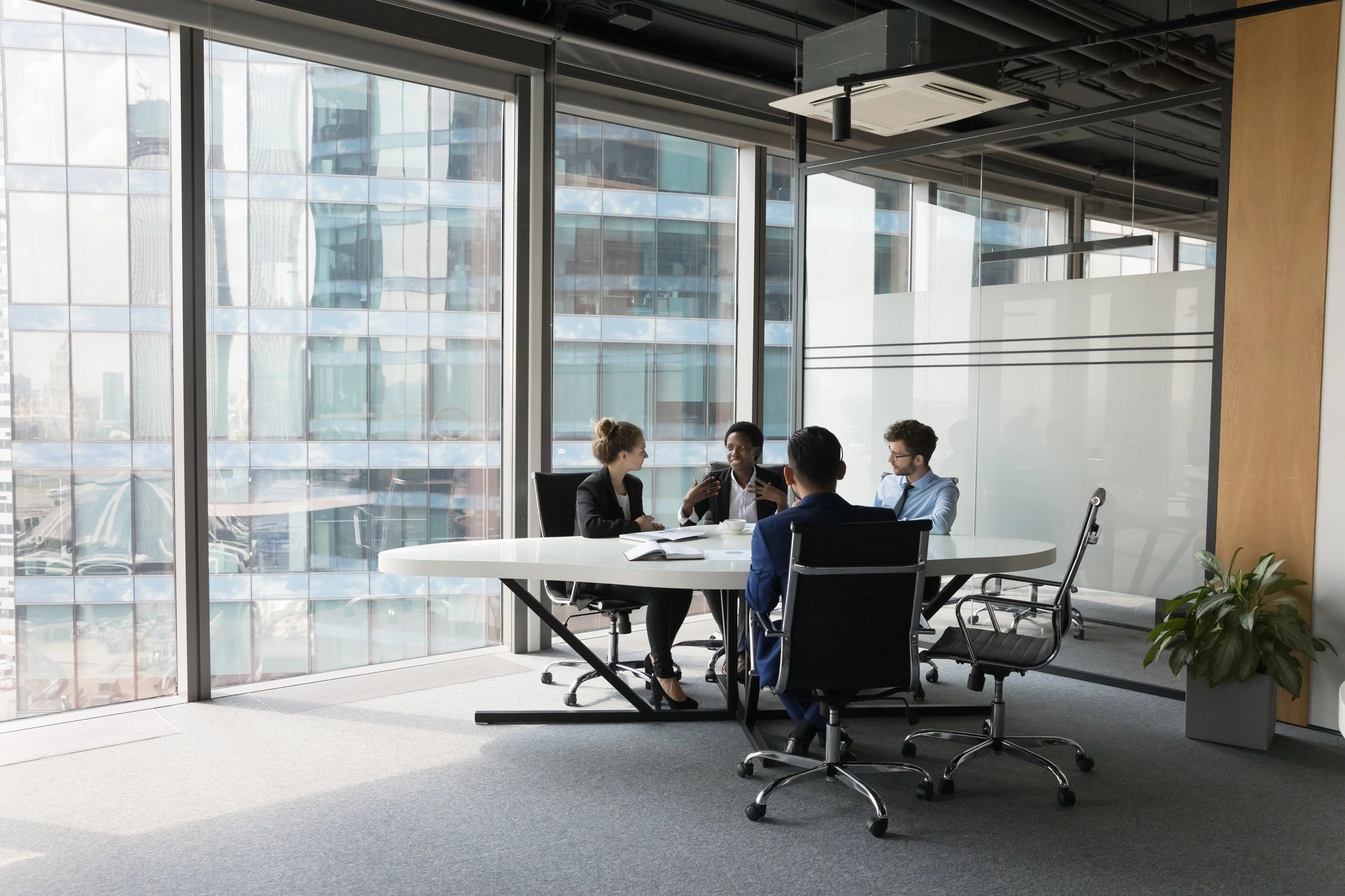 Cairmont Capital team collaborating in a modern office meeting room
