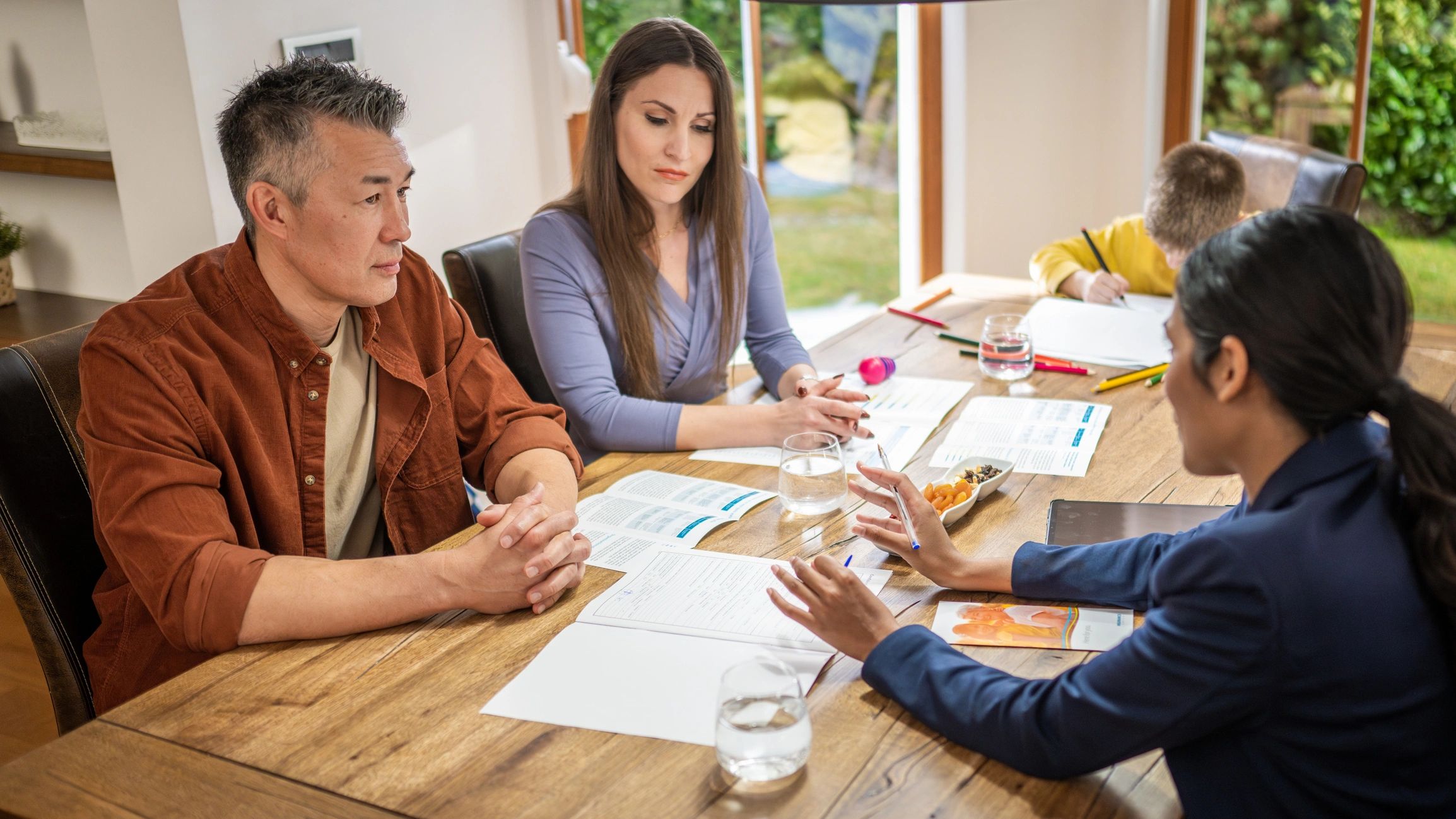 Professionals reviewing mortgage documents together