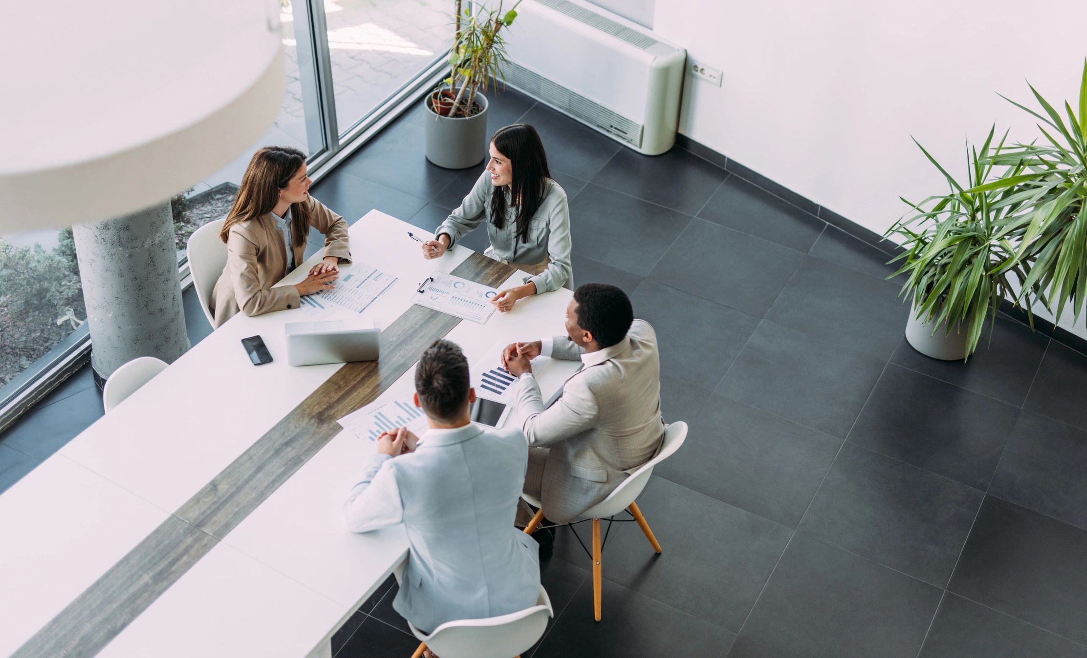Business team reviewing strategy together around a conference table