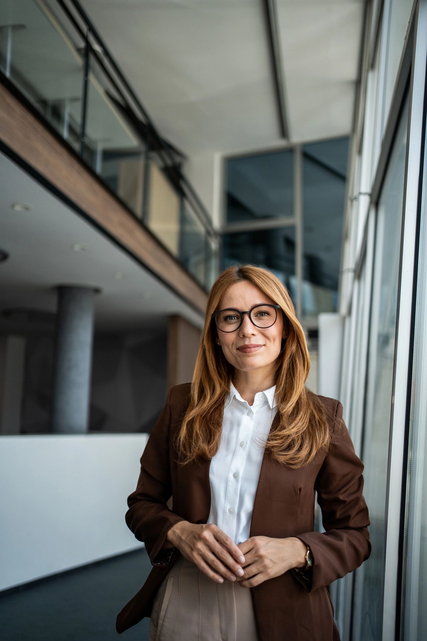 Professional business leader standing confidently in a modern office