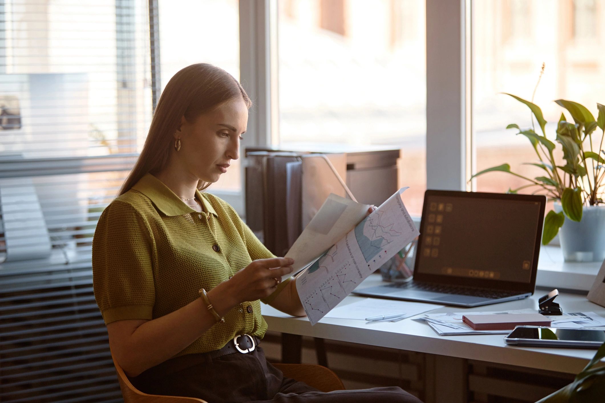 Professional reviewing financial reports in an office